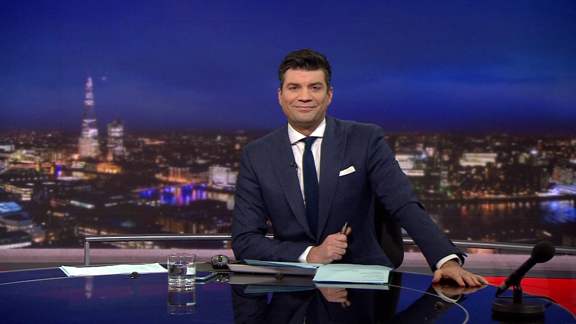 Lewis Vaughan Jones reading the news in TV studio