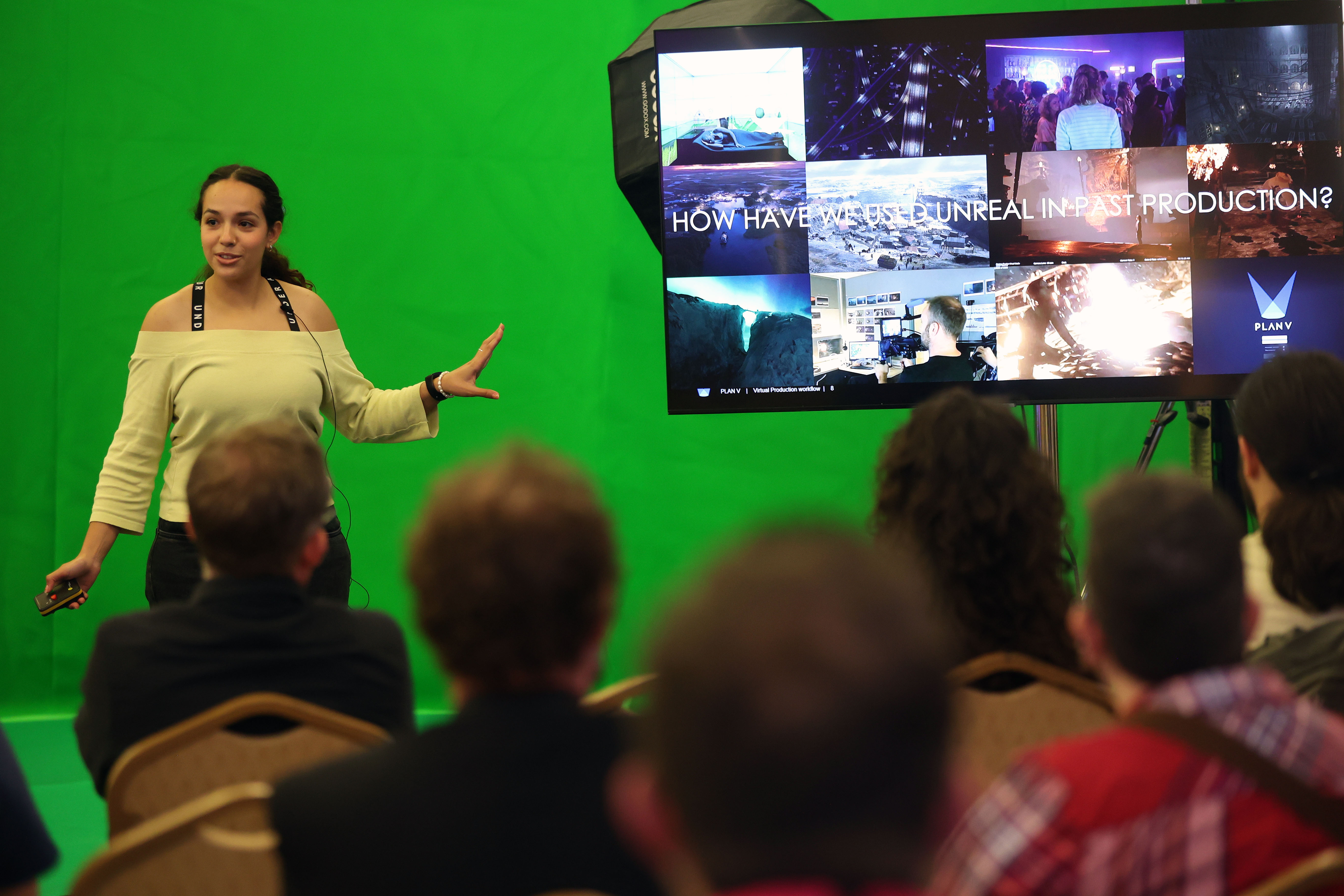 Yassmine Najimi of Painting Practice presents Plan V on TV screen infront of green screen
