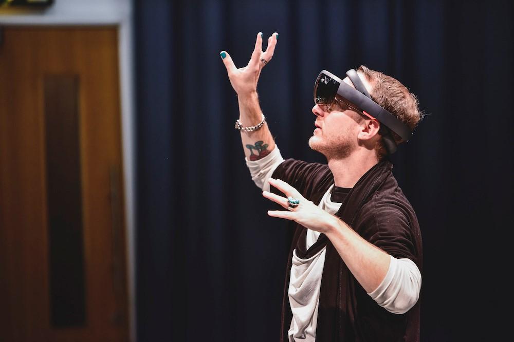 Choreographer creating movement with arms wearing AR equipment 